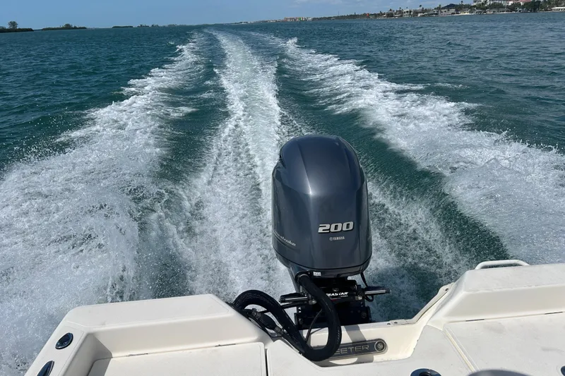 Slide: The Image of Skeeter SX2250 boat with Yamaha 200 engine cruising on open water, 2022 model. - 20