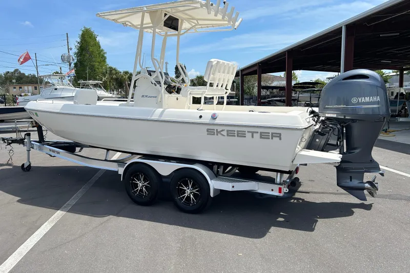 Slide: The Image of 2022 Skeeter SX2250 boat with Yamaha engine on trailer in marina setting. - 4