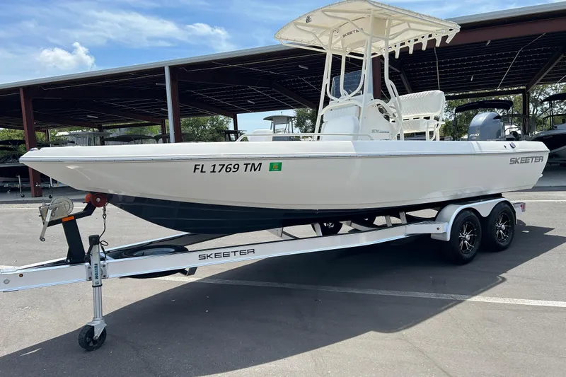 Slide: The Image of 2022 Skeeter SX2250 boat on trailer, parked outdoors under a canopy. - 5
