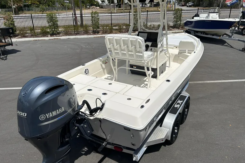Slide: The Image of 2022 Skeeter SX2250 boat with Yamaha engine, parked on a trailer in a sunny lot. - 7