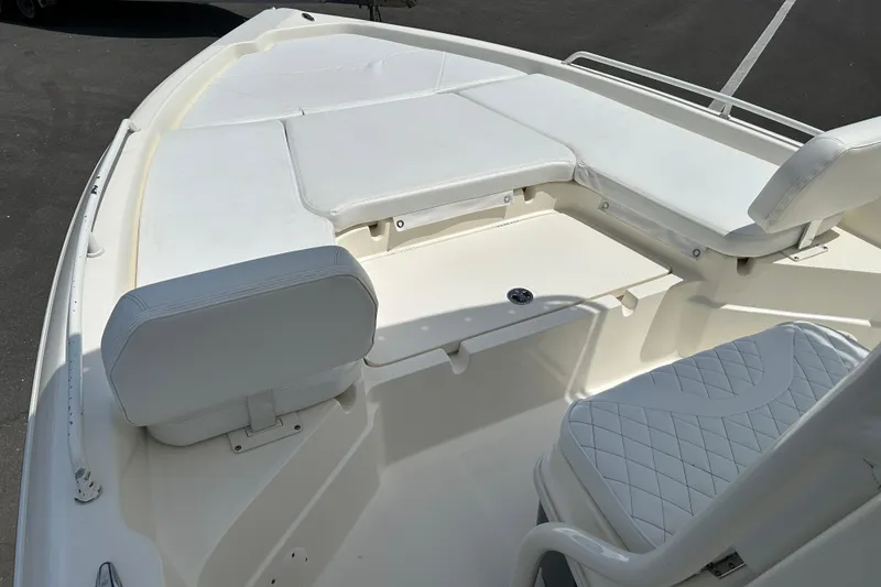 Slide: The Image of 2022 Skeeter SX2250 boat interior with white cushioned seating and storage compartments. - 8