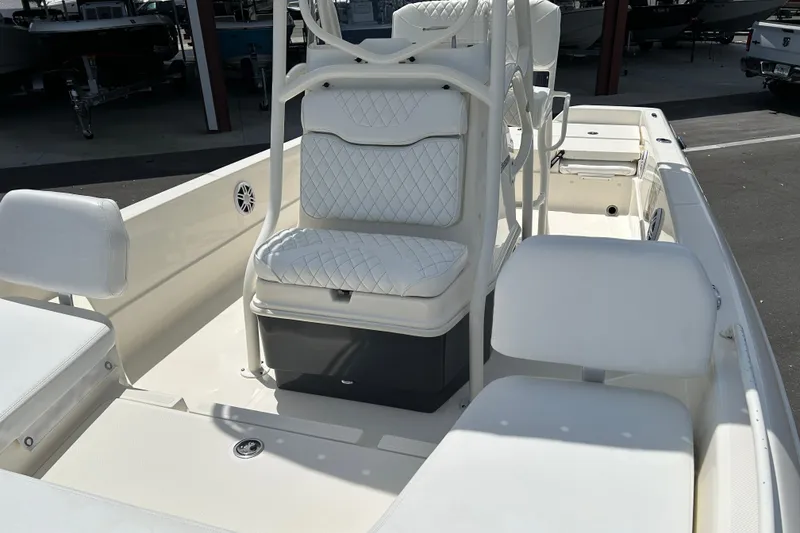 Slide: The Image of 2022 Skeeter SX2250 boat interior with white cushioned seating and storage compartments. - 9