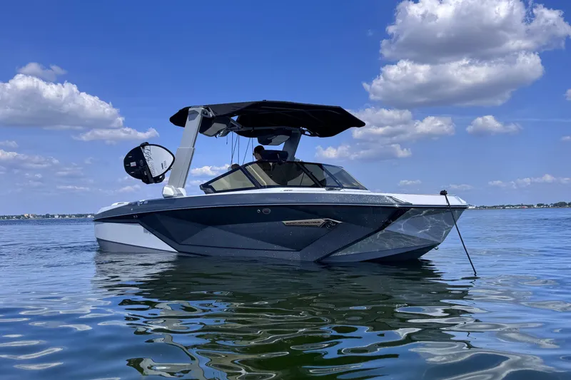 The Image of 2024 Nautique Super Air Nautique G23 boat on calm water under blue sky. - 0