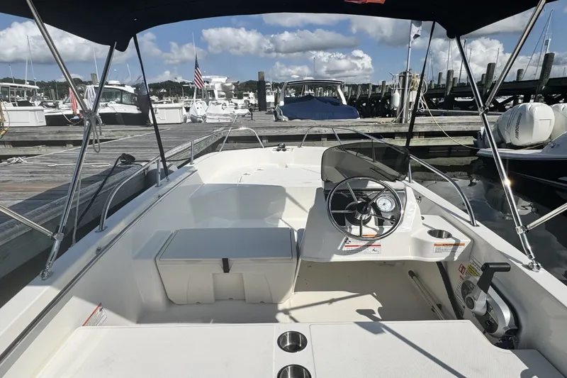 Slide: The Image of The image shows a 2027 Boston Whaler 160 Super Sport boat in a marina. - 15