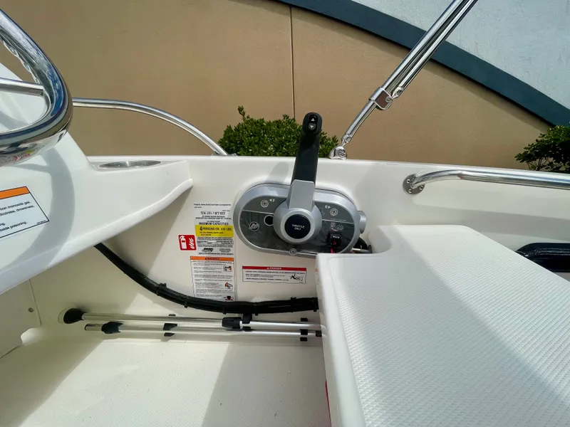 Slide: The Image of The image shows the cockpit of a 2027 Boston Whaler 130 Super Sport with a steering console and bench seat. - 6