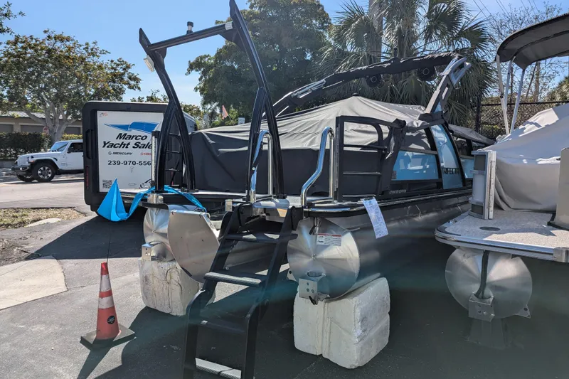 Slide: The Image of 2026 Trifecta 23SB2 SS pontoon boat displayed at yacht sales lot. - 1