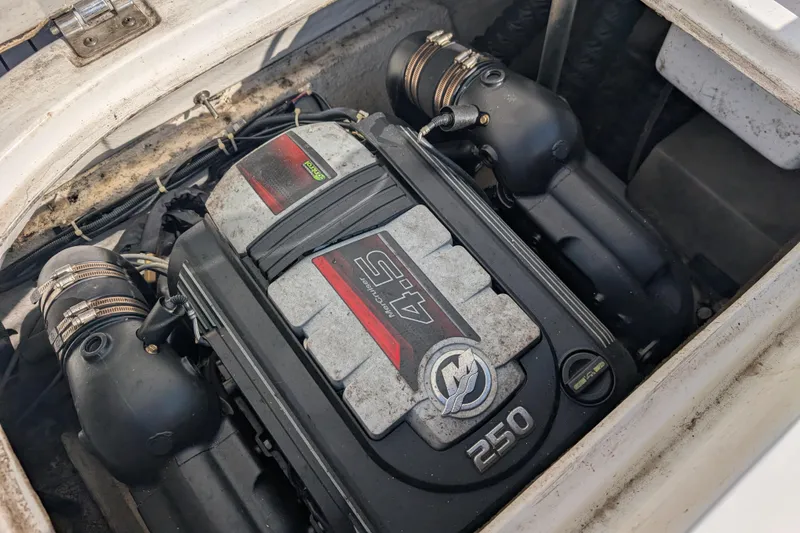 Slide: The Image of Engine compartment of a 2017 Hurricane SunDeck Sport 201 IO boat, featuring a 250 horsepower motor. - 11