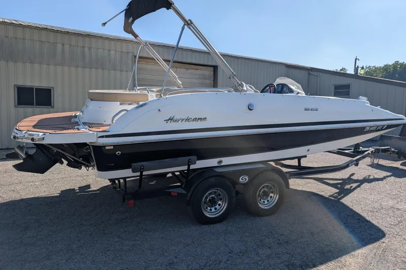 Slide: The Image of 2017 Hurricane SunDeck Sport 202 IO boat on trailer, parked outdoors. - 13