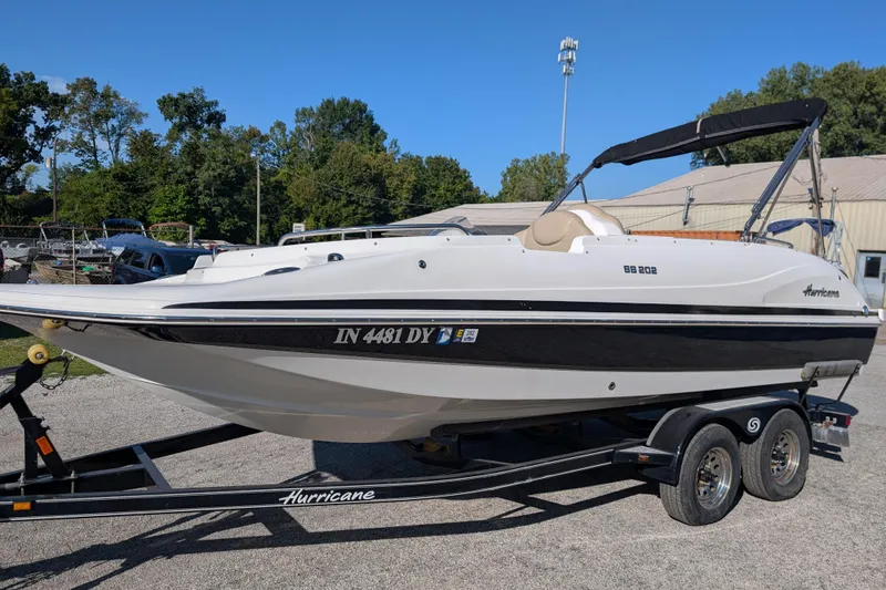 Slide: The Image of 2017 Hurricane SunDeck Sport 202 IO boat on trailer, parked outdoors. - 3
