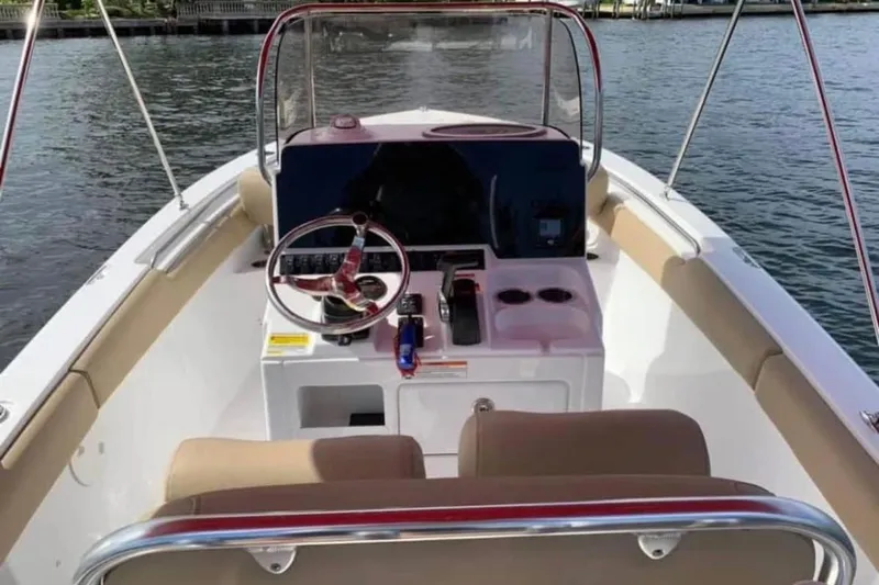 Slide: The Image of 2018 Sea Hunt Ultra 211 boat interior with steering console and seating. - 5