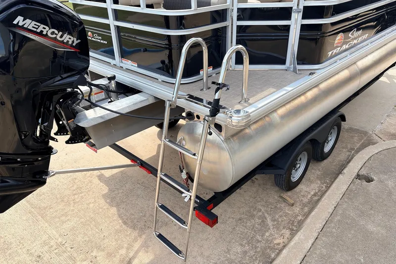 Slide: The Image of 2025 Sun Tracker SportFish 20 DLX pontoon boat on trailer with Mercury engine. - 10