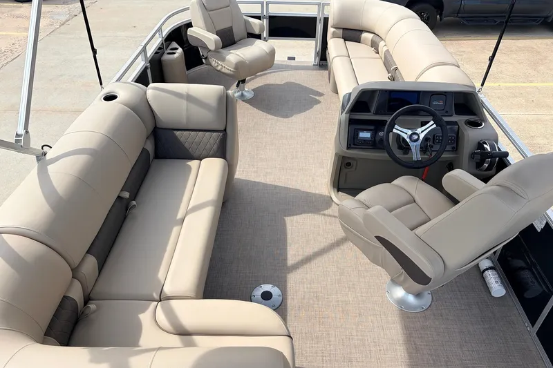 Slide: The Image of 2025 Sun Tracker SportFish 20 DLX pontoon boat interior with beige seating and steering console. - 12