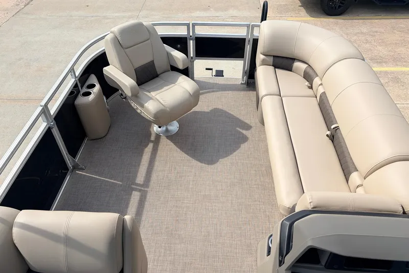 Slide: The Image of 2025 Sun Tracker SportFish 20 DLX interior with beige seating and cup holders. - 13