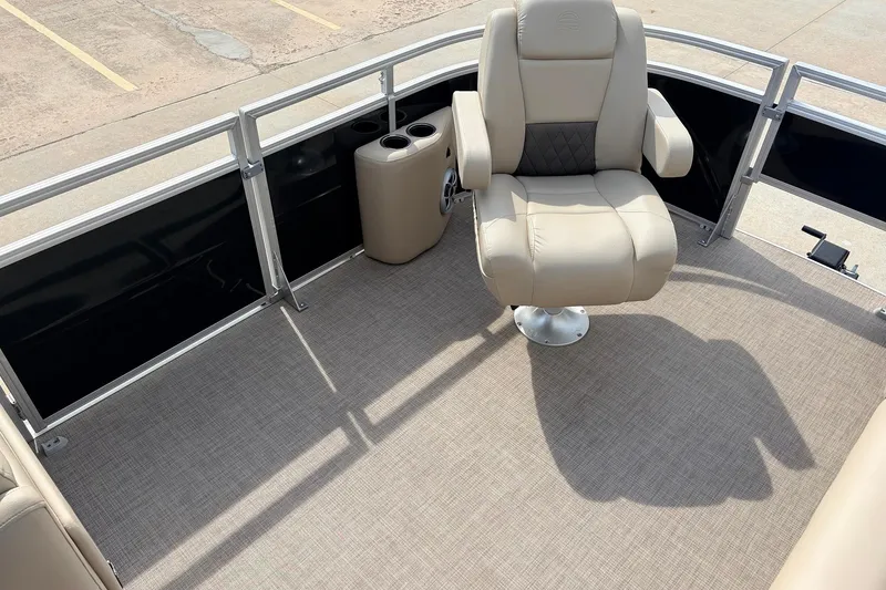 Slide: The Image of 2025 Sun Tracker SportFish 20 DLX boat interior with beige captain's chair and cup holders. - 14