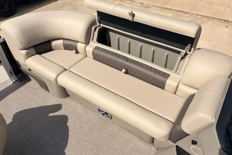 Slide: The Image of 2025 Sun Tracker SportFish 20 DLX pontoon boat with beige seating and storage compartment. - 17