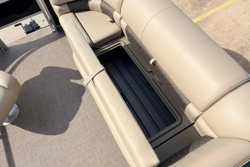 Slide: The Image of 2025 Sun Tracker SportFish 20 DLX boat interior with beige seating and storage compartment. - 18