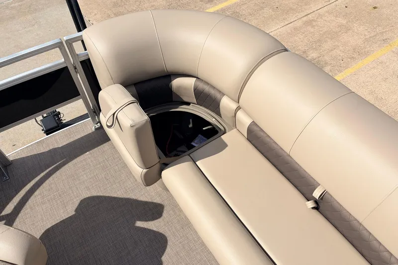 Slide: The Image of 2025 Sun Tracker SportFish 20 DLX boat interior with beige seating and storage compartment. - 19