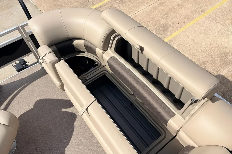 Slide: The Image of 2025 Sun Tracker SportFish 20 DLX boat interior with beige seating and storage compartments. - 20