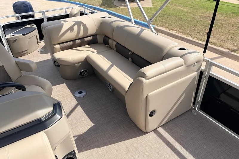 Slide: The Image of 2025 Sun Tracker SportFish 20 DLX interior with beige seating and spacious layout. - 21