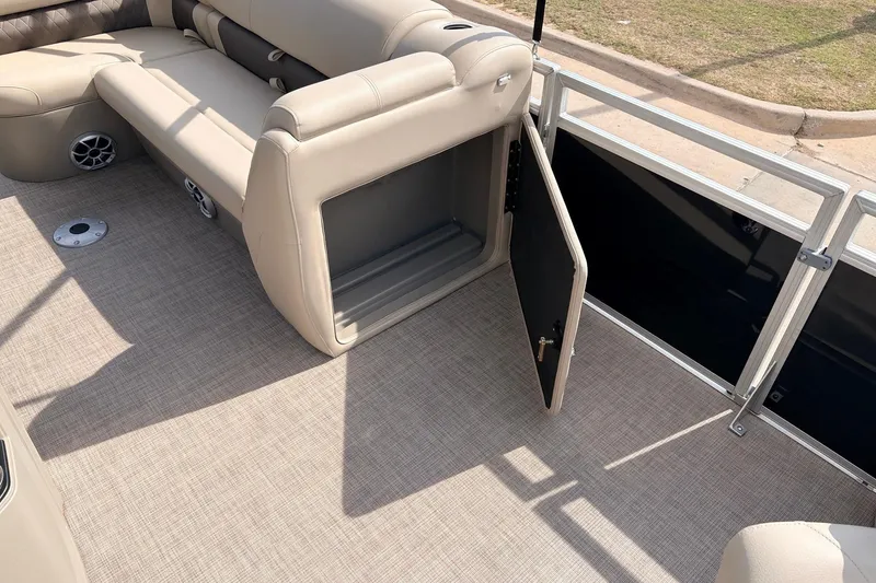 Slide: The Image of 2025 Sun Tracker SportFish 20 DLX pontoon boat interior with open storage compartment. - 22