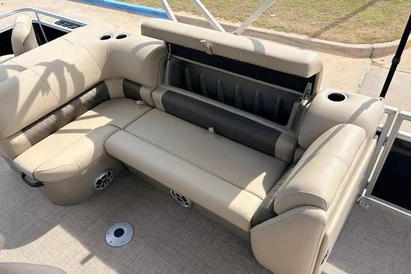 Slide: The Image of 2025 Sun Tracker SportFish 20 DLX boat interior with beige seating and storage compartment. - 23