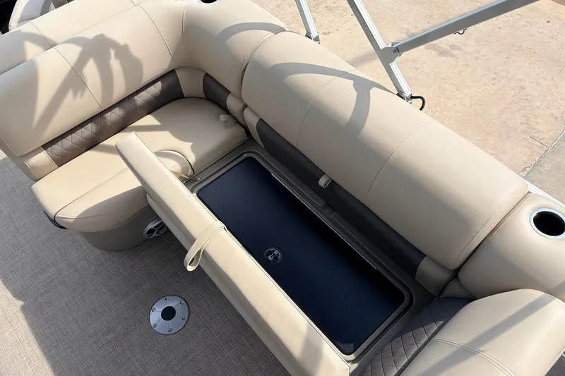 Slide: The Image of 2025 Sun Tracker SportFish 20 DLX boat seating with storage compartment and cup holders. - 24