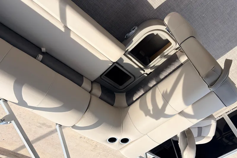 Slide: The Image of 2025 Sun Tracker SportFish 20 DLX boat interior with beige seating and storage compartments. - 26