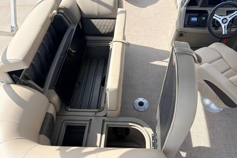 Slide: The Image of 2025 Sun Tracker SportFish 20 DLX interior with beige seating and storage compartments. - 27