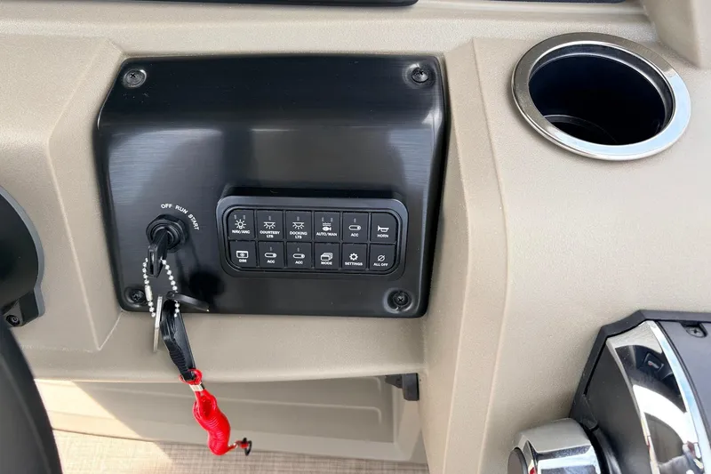 Slide: The Image of Control panel of 2025 Sun Tracker SportFish 20 DLX boat with ignition and switches. - 32