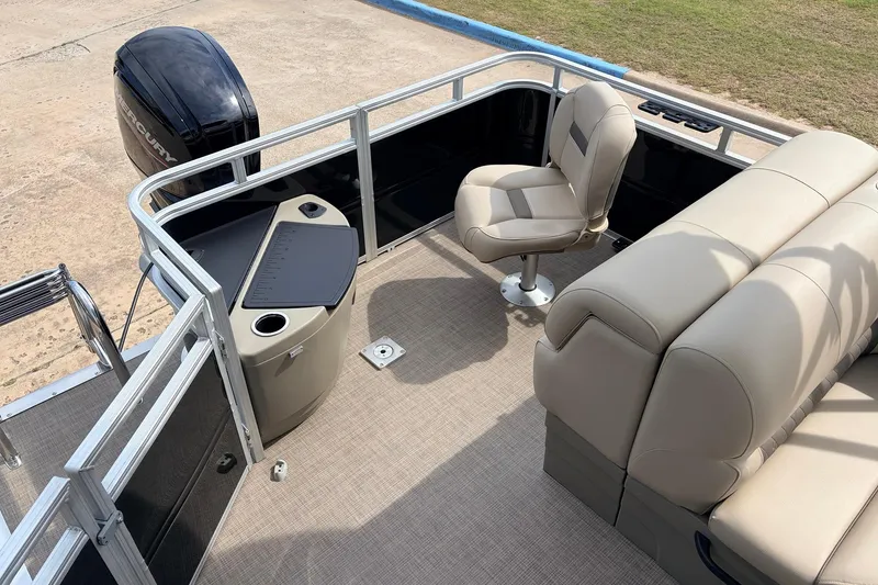 Slide: The Image of 2025 Sun Tracker SportFish 20 DLX pontoon boat interior with seating and Mercury outboard motor. - 34