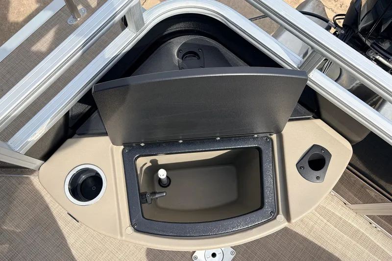 Slide: The Image of 2025 Sun Tracker SportFish 20 DLX boat storage compartment with cup holder and utility space. - 39