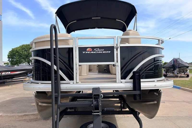 Slide: The Image of 2025 Sun Tracker SportFish 20 DLX pontoon boat on trailer, outdoor display. - 4
