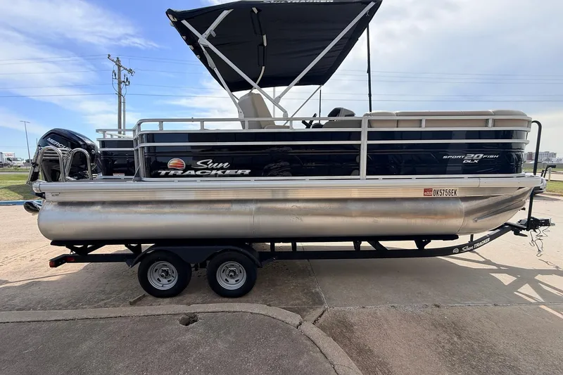 Slide: The Image of 2025 Sun Tracker SportFish 20 DLX pontoon boat on trailer, side view. - 6