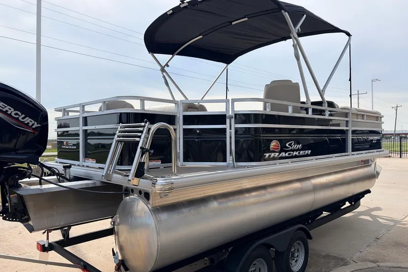 Slide: The Image of 2025 Sun Tracker SportFish 20 DLX pontoon boat with Mercury engine on trailer. - 7