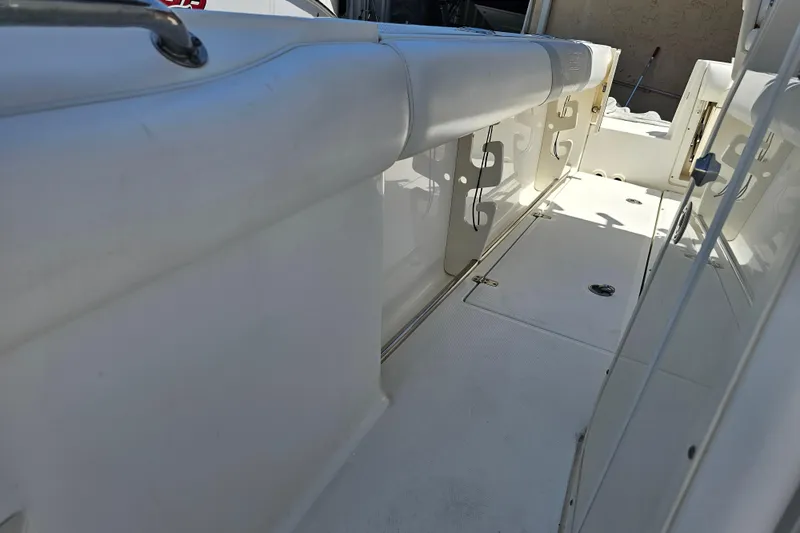 Slide: The Image of Interior view of a 2012 Boston Whaler 220 Outrage boat, showcasing seating and storage. - 13