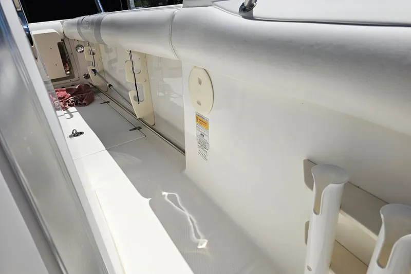 Slide: The Image of Boston Whaler 220 Outrage 2012 boat seats with white upholstery and helm view. - 14