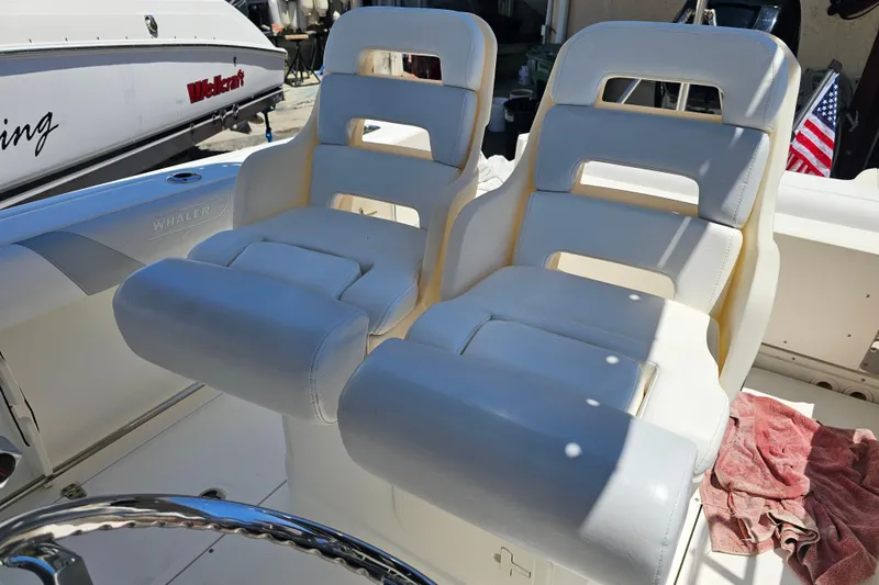 Slide: The Image of 2012 Boston Whaler 220 Outrage boat interior with steering wheel and control panel. - 16