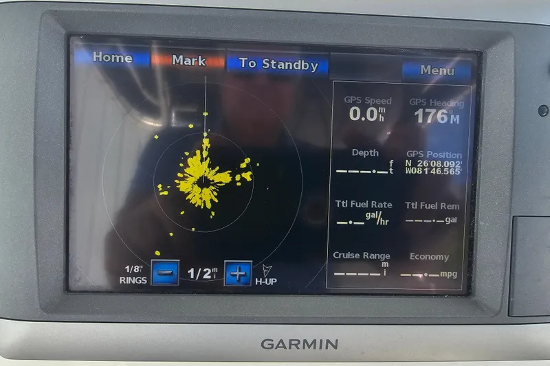 Slide: The Image of 2012 Boston Whaler 220 Outrage electronics compartment with Raymarine equipment installed. - 19