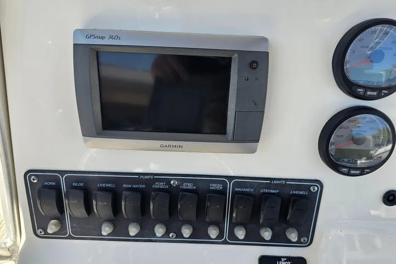 Slide: The Image of Steering wheel and controls of a 2012 Boston Whaler 220 Outrage boat. - 20