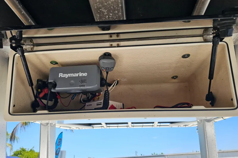 Slide: The Image of 2012 Boston Whaler 220 Outrage boat interior with open storage compartment and seating. - 21
