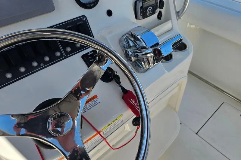 Slide: The Image of 2012 Boston Whaler 220 Outrage interior with battery compartment and fire extinguisher. - 23