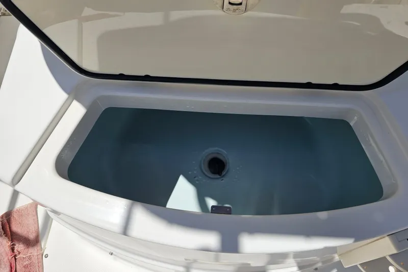 Slide: The Image of 2012 Boston Whaler 220 Outrage boat interior with seating and American flag. - 25
