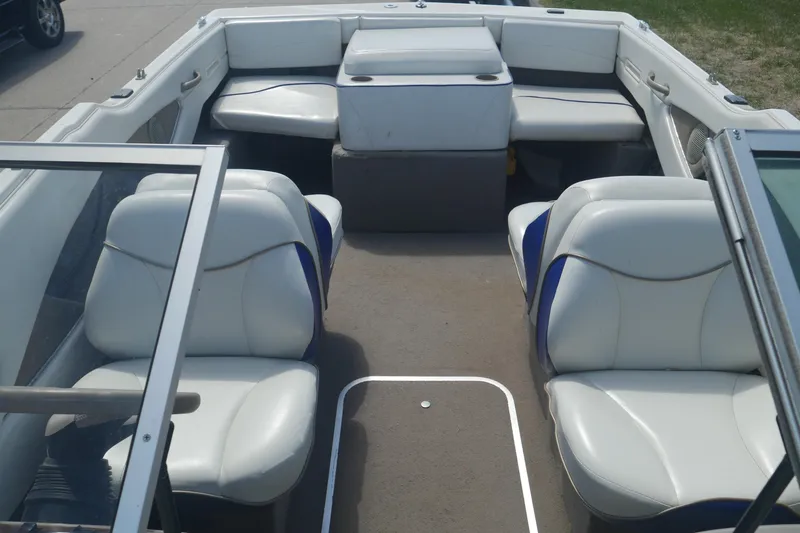 Slide: The Image of Interior of a 2003 Bayliner 194 boat with white seating and open layout. - 17