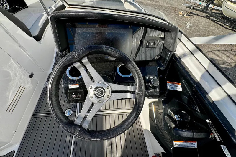 Slide: The Image of 2019 Yamaha Boats 242 Limited S steering wheel and dashboard, featuring sleek design and controls. - 6