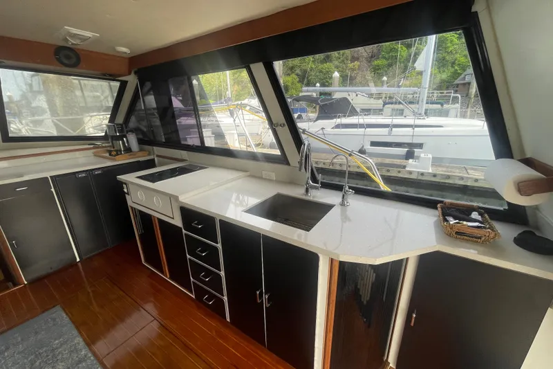 Slide: The Image of Interior of 1986 Hi-Star 40 Flybridge yacht with modern kitchen and large windows. - 10