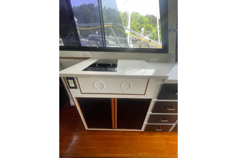 Slide: The Image of 1986 Hi-Star 40 Flybridge yacht kitchen with stove, countertop, and window view. - 12