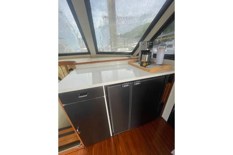 Slide: The Image of 1986 Hi-Star 40 Flybridge interior with countertop, cabinets, and coffee maker setup. - 15