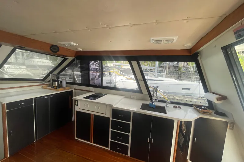 Slide: The Image of Interior of 1986 Hi-Star 40 Flybridge yacht with modern kitchen and large windows. - 16