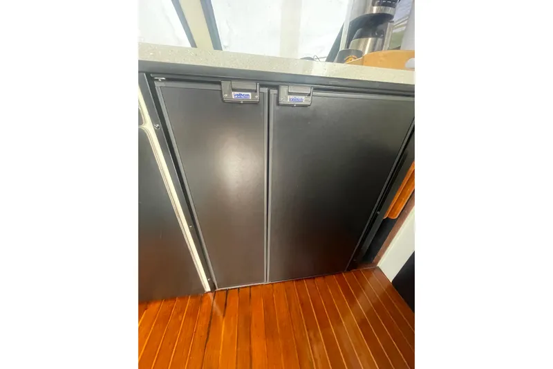 Slide: The Image of Built-in fridge on 1986 Hi-Star 40 Flybridge yacht with wooden flooring. - 17