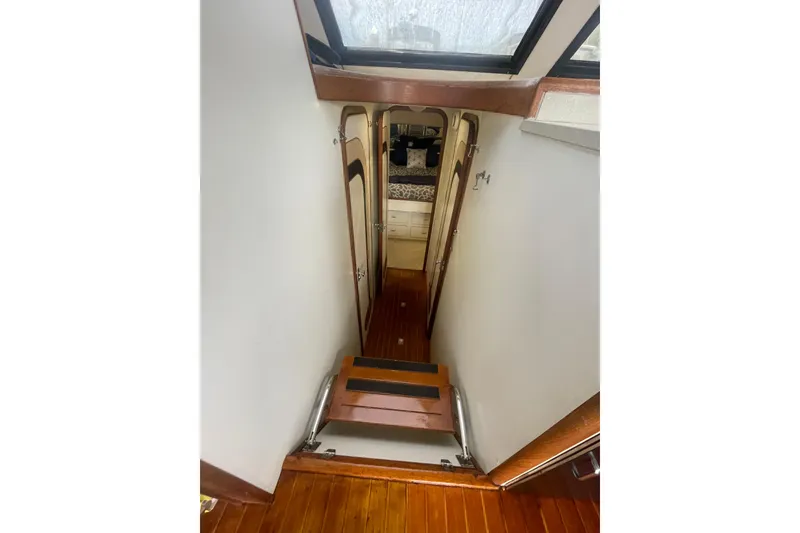 Slide: The Image of 1986 Hi-Star 40 Flybridge interior with wooden stairs and cabin view. - 21